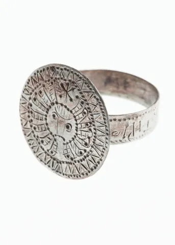 Bronze finger ring, covered in silver, with beheaded Gorgo/Medusa head on the bezel, and the inscription "protecting the womb" on the band, 10th c. AD (cat. no. MF 7677)